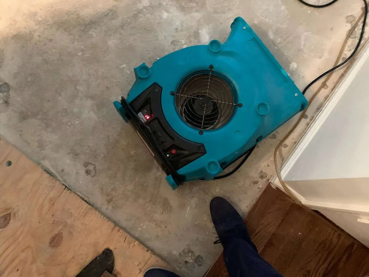 Air mover drying subfloor during Commercial Water Damage Restoration in Park Hills